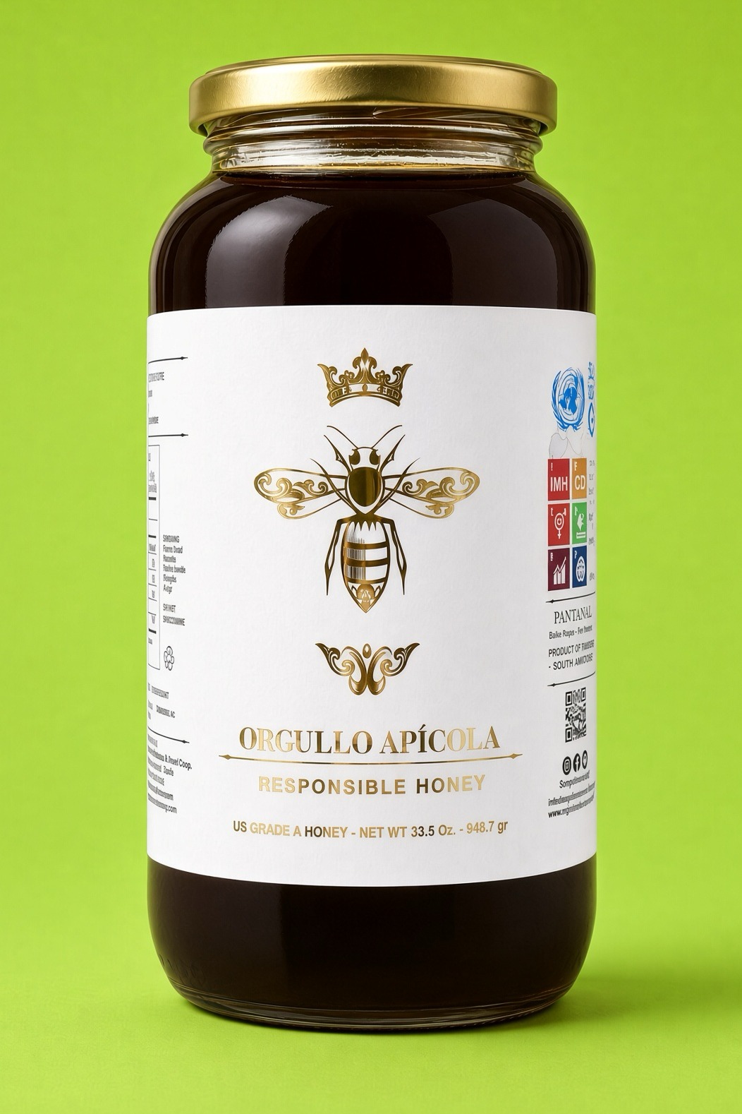 A glass jar of amber honey with a gold lid and a white label bearing a crowned bee