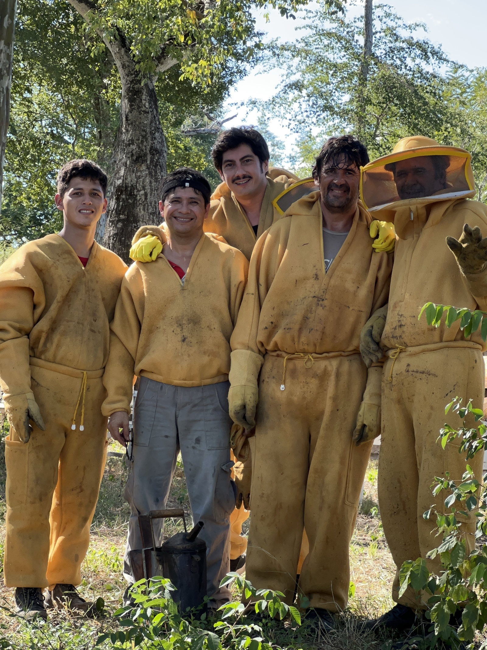Roger Velilla with the licensed indigenous beekeepers in yellow suits
